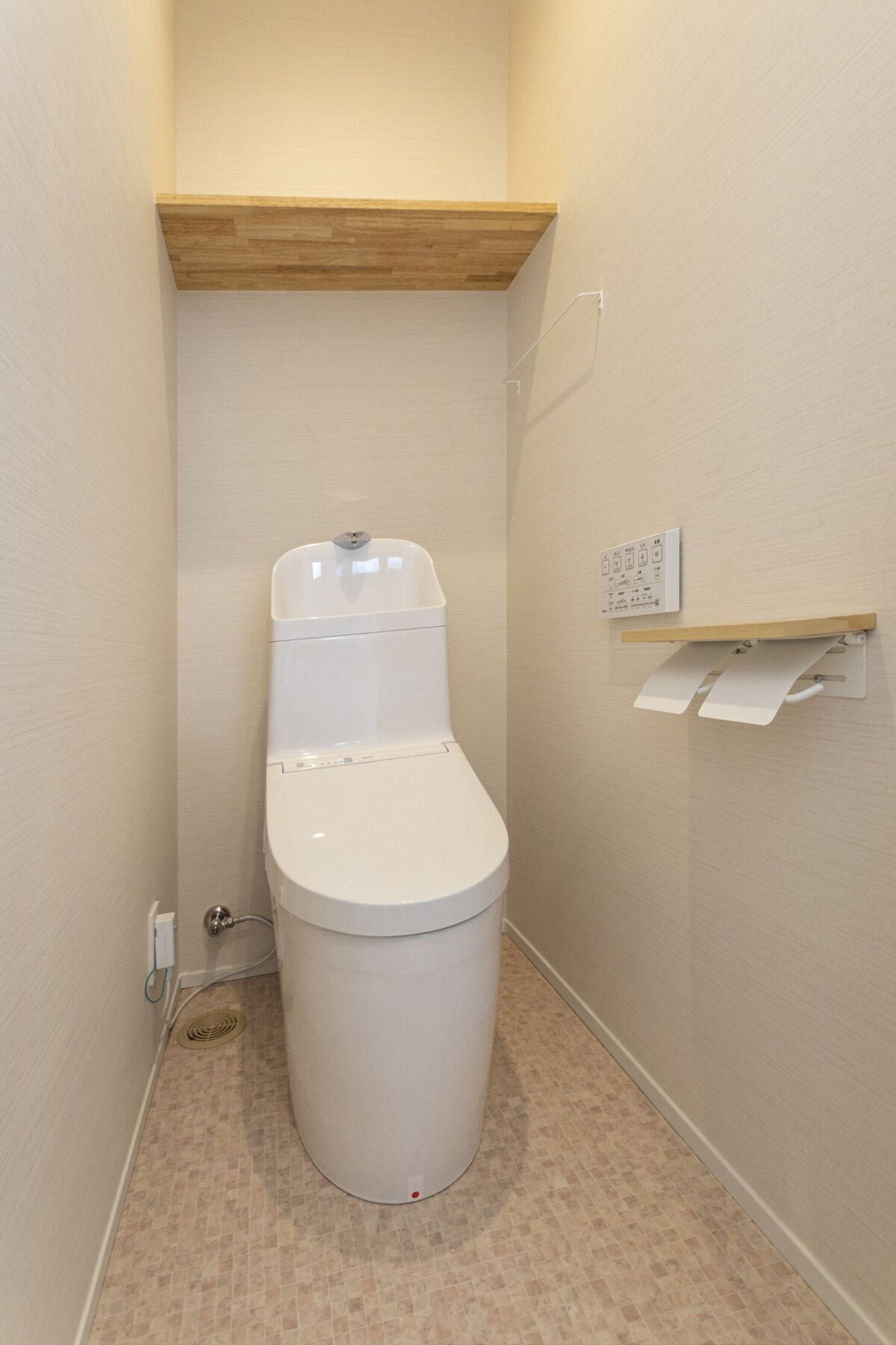 >2階のトイレは1階と違い可愛らしい印象に。上部の棚はゴムの集成材で造作しました。　写真