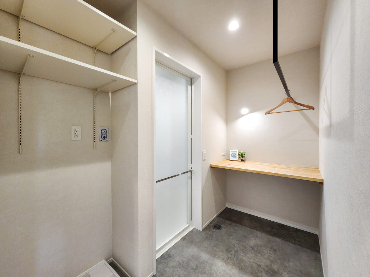 >アイアン物干しと家事カウンターがある脱衣室　写真